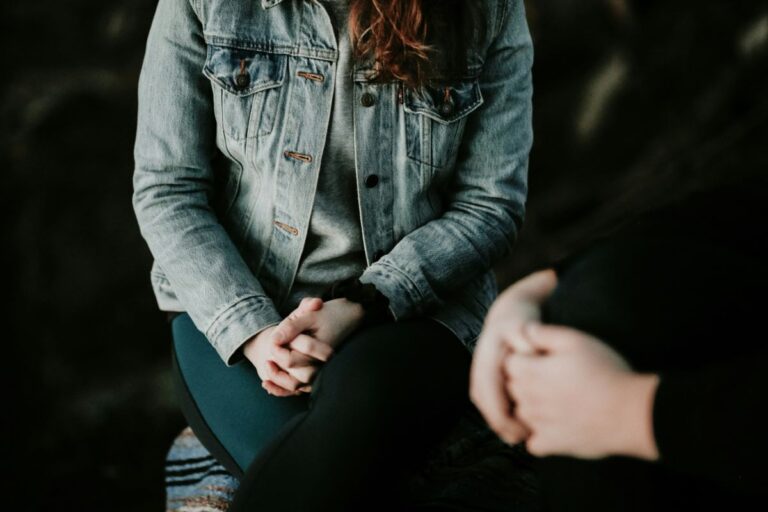 two people sitting together in a counselling room