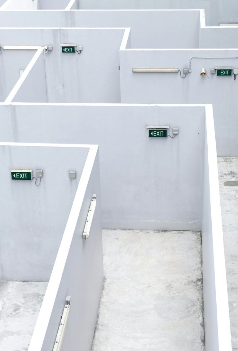 Maze of white corridors with numerous exit signs